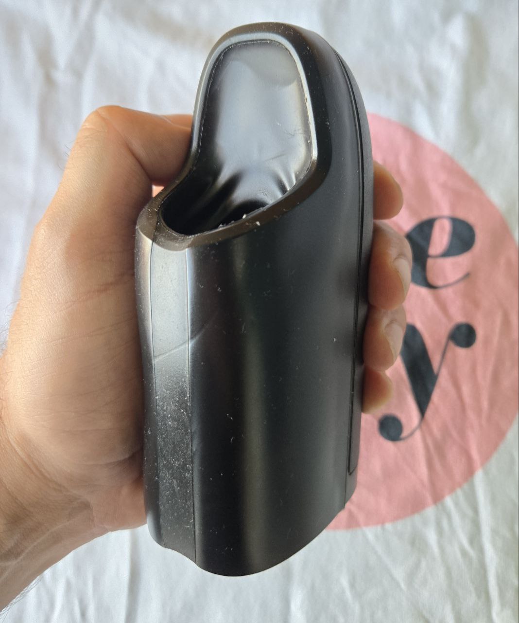 Arcwave Ion being held for scale—shows how it fits in hand and supports one-handed use during sessions