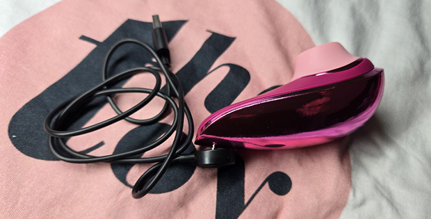 Magnetic USB charger connected to my Womanizer Liberty 2—demonstrating how the charging cable attaches in real use