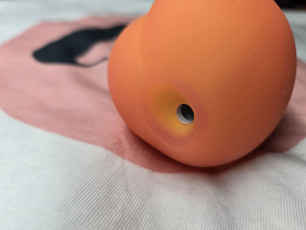 Close-up view of Womanizer Peach suction mouth showing oval-shaped opening and soft silicone rim