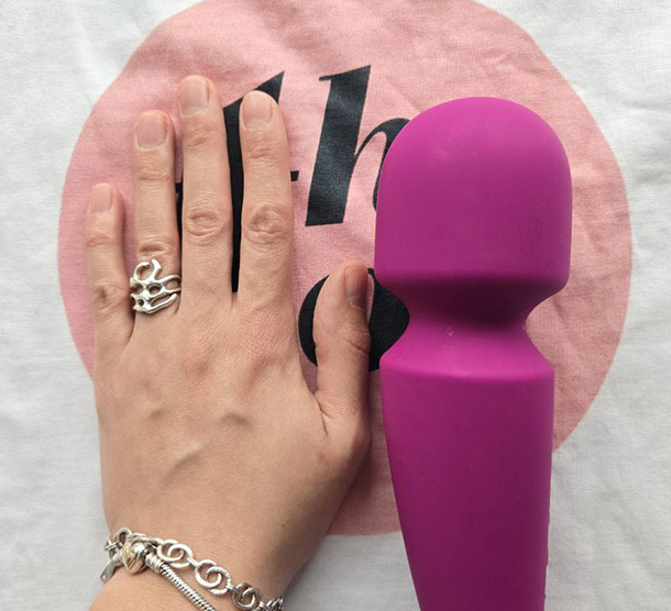 LELO Smart Wand 2 next to a small female palm.