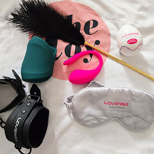 Lovense Lover Set, including Lush 4 G-spot wearable, the Gush 2 penis massager, a blindfold, cuffs, a feather tickler, and a textured Kraken sleeve