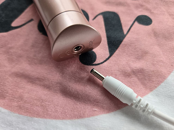 Le Wand Petite charging port and charging cable.