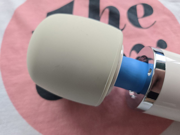 Close-up of the Magic Wand Plus's rounded white silicone head, showing the smooth surface texture and slight neck flexibility.