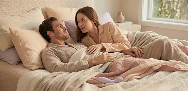 Two partners staying close and communicating during a brief pause without breaking intimacy.