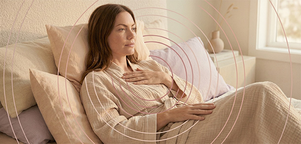 Thoughtful woman in a quiet bedroom reflecting on arousal difficulties with a calm and self-supportive mood.