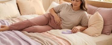 Woman pausing briefly to adjust during solo pleasure while staying relaxed and connected to the moment.