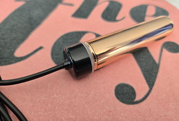 Le Wand Bullet connected to its USB charging cable.