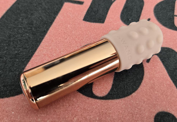 Le Wand Bullet full view of its metal body and silicone hood attachment.