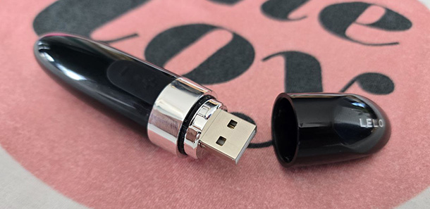 LELO Mia 2 with twist-off cap removed, revealing the built-in USB charging connector.