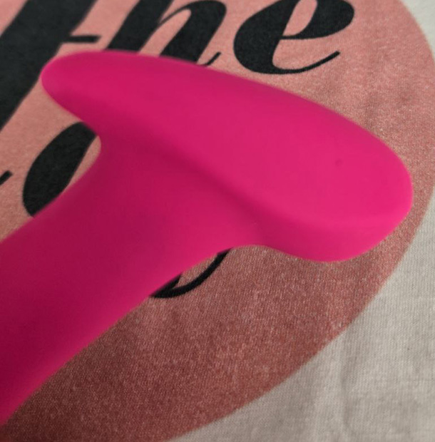 Close-up of the Lovense Ambi's rounded silicone head, showing the smooth surface that filters the motor's harmonic content into a softer contact feel.