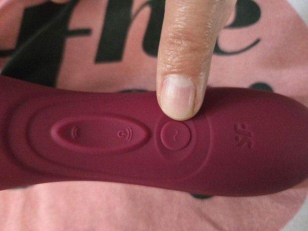 Back view of Satisfyer Pro 2 Generation 3 showing three control buttons with annotated labels: up arrow button increases air pulse intensity, down arrow button turns on air pulse and decreases intensity, and separate round button controls the vibration motor.