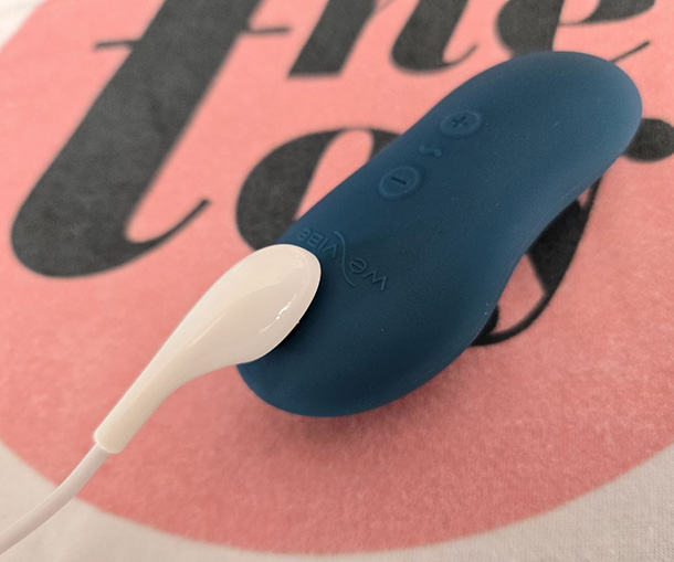 We-Vibe Touch X attached to its magnetic charger