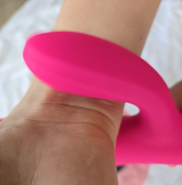 Lovense Velvo clit arm pressed against body tissue to measure vibration behavior under body pressure.
