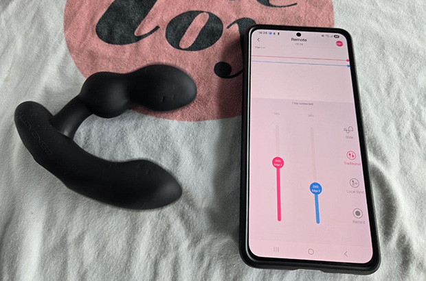 Lovense Edge 2 next to a phone with its app control open