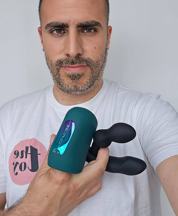 Michael Sampson demonstrating Lovense Edge 2 and Lovense Gush 2 in one hand next to each other.