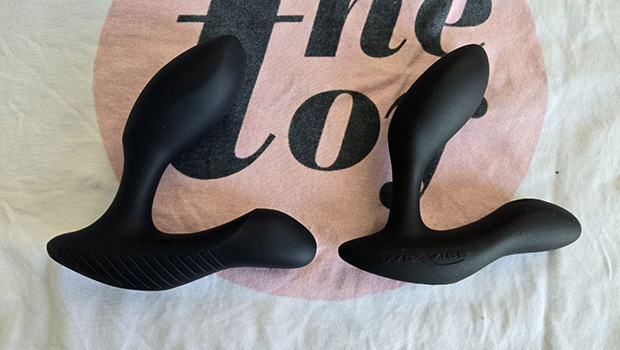 Arcwave Perk prostate massager next to We-Vibe Vector+, displaying their very similar L-shaped designs and adjustable insertable arms
