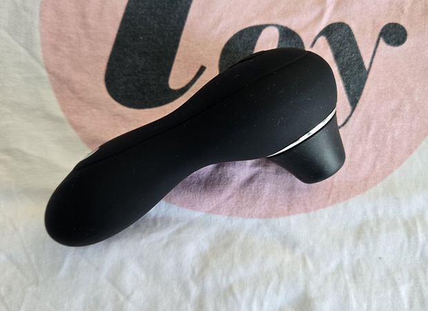 Lovehoney Thrill Clitoral Suction Stimulator in black, on its side, demonstrating its compact size and ergonomic body shape