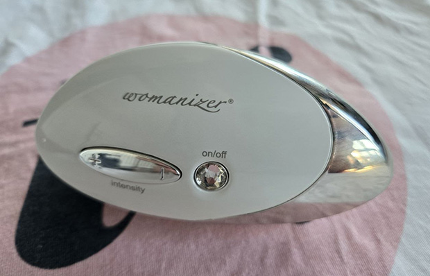 Womanizer w500 back side with the controls and the luxury design with the swarovski stone on/off button