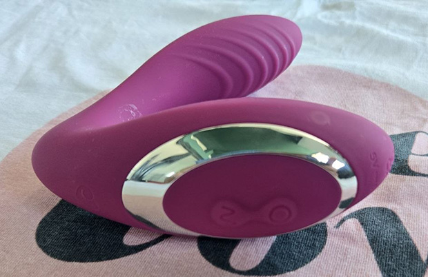 Full-length photo of the raspberry-colored Lovehoney Mon Ami dual stimulator showing its curved G-spot arm and clitoral suction head with two visible control buttons on the body.
