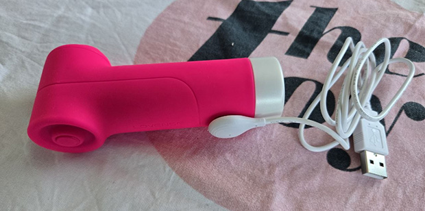 Lovense Fizz connected to its magnetic charger