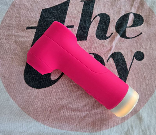 the Lovense Fizz demonstrating its slim cylindrical shape and natural finger placement on the side-mounted control buttons