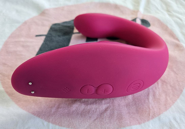 The Womanizer Blend's three control buttons—plus, minus, and diamond—highlighted on the smooth silicone body of the toy.