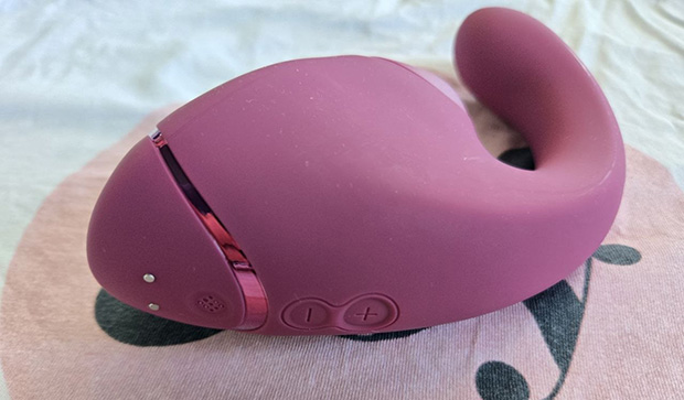 Rear control panel of the Womanizer Next Duo showing three smaller buttons for G-spot vibration intensity, decreasing intensity, and cycling through vibration patterns.
